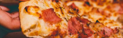 Close-Up Photo of Person Holding Pizza